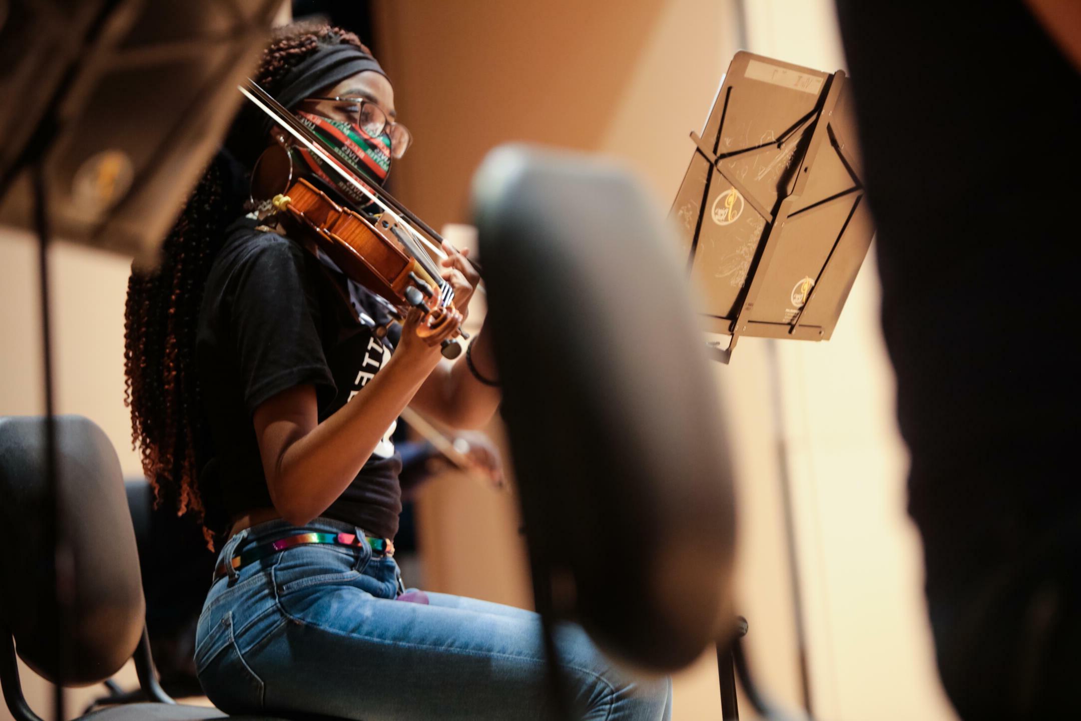 female student playing a violin